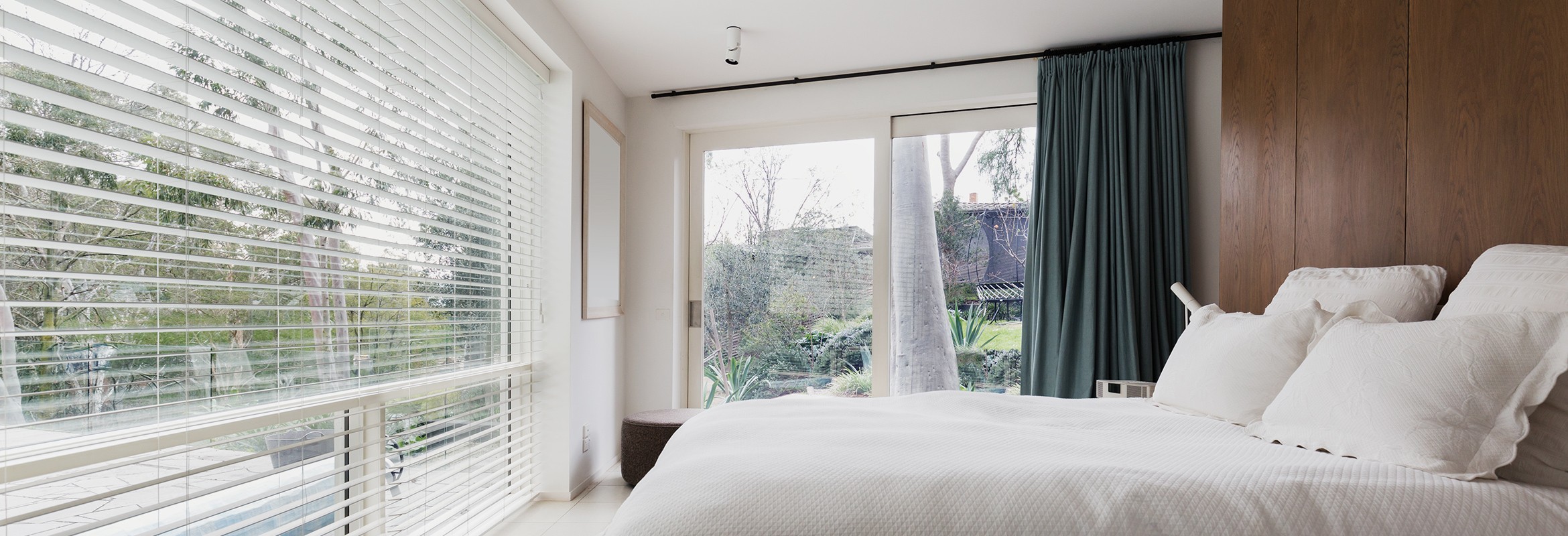 Large white aluminium window in bedroom